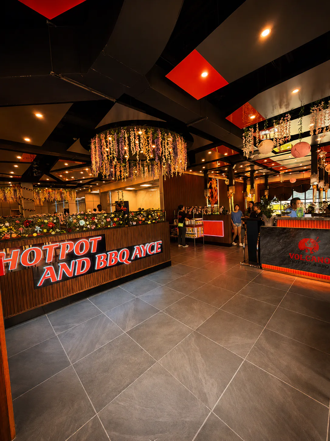 Volcano Hot Pot & BBQ AYCE restaurant interior with modern lighting and floral decor